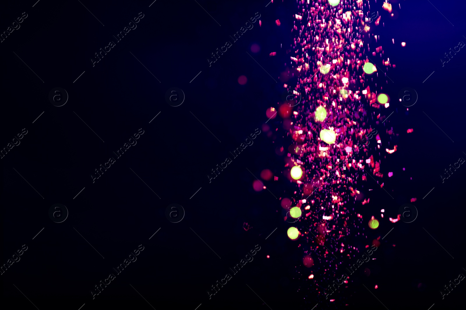 Image of Purple glitter falling on dark background, space for text. Halloween backdrop