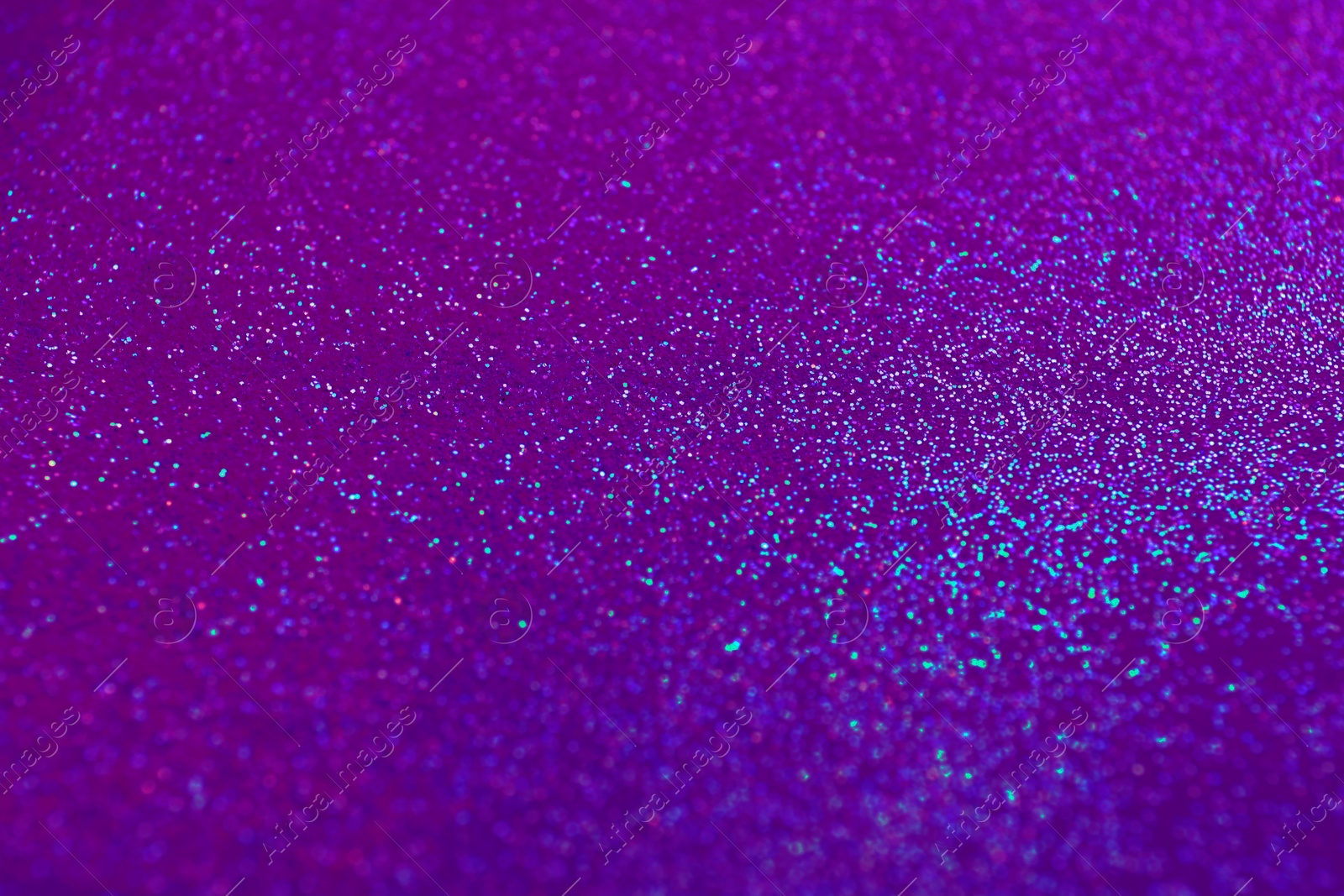 Image of Shiny violet and blue glitter, closeup. Halloween background, bokeh effect