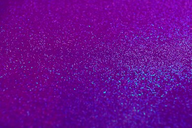 Image of Shiny violet and blue glitter, closeup. Halloween background, bokeh effect