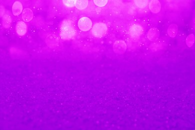 Image of Shiny violet glitter, closeup. Halloween background, bokeh effect