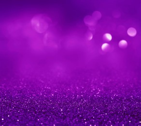 Image of Shiny purple glitter, closeup. Halloween background, bokeh effect