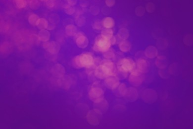 Image of Pink blurred lights on violet blue gradient backdrop, bokeh effect. Halloween background