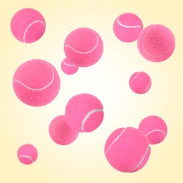 Image of Many pink tennis balls flying on beige background