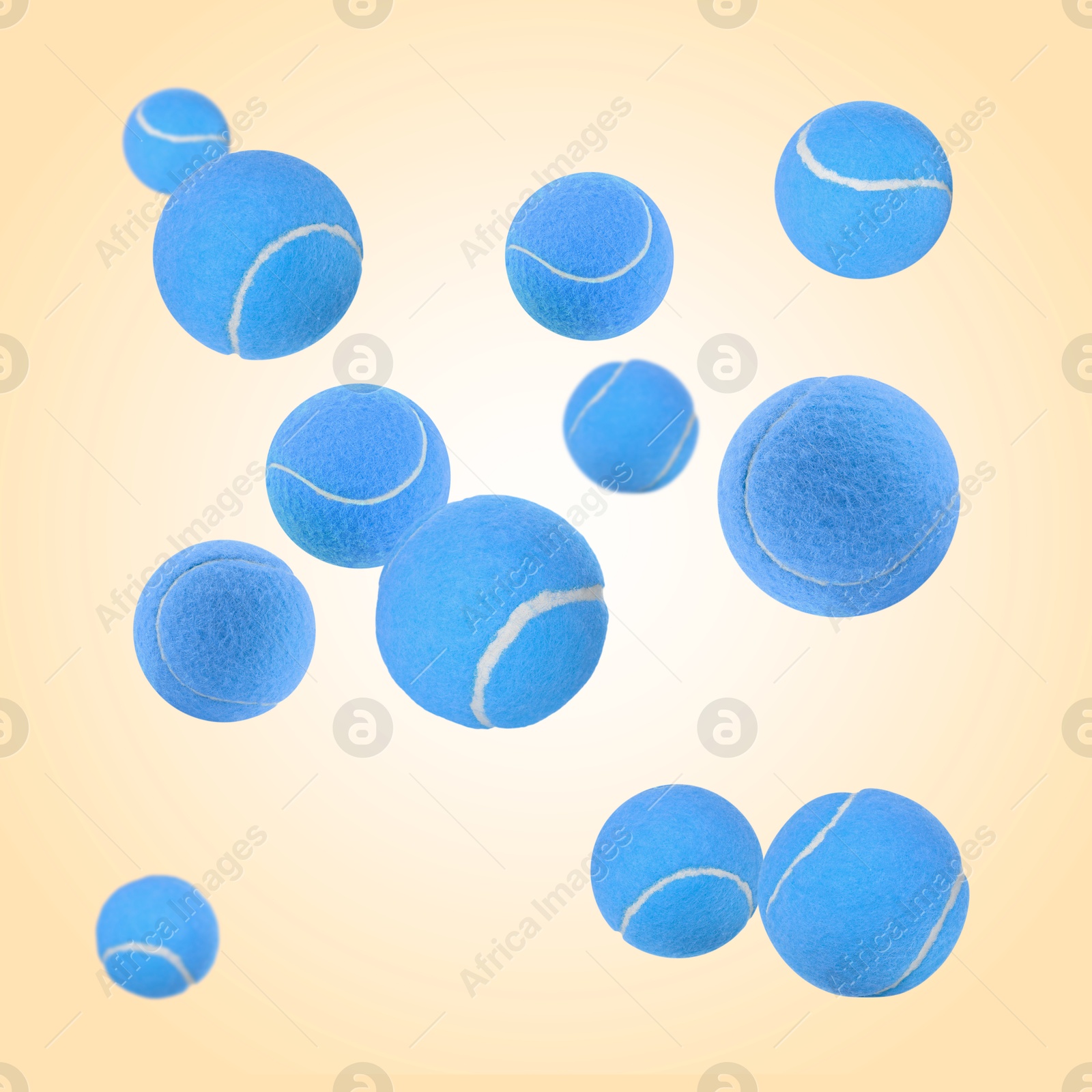 Image of Many light blue tennis balls flying on beige background