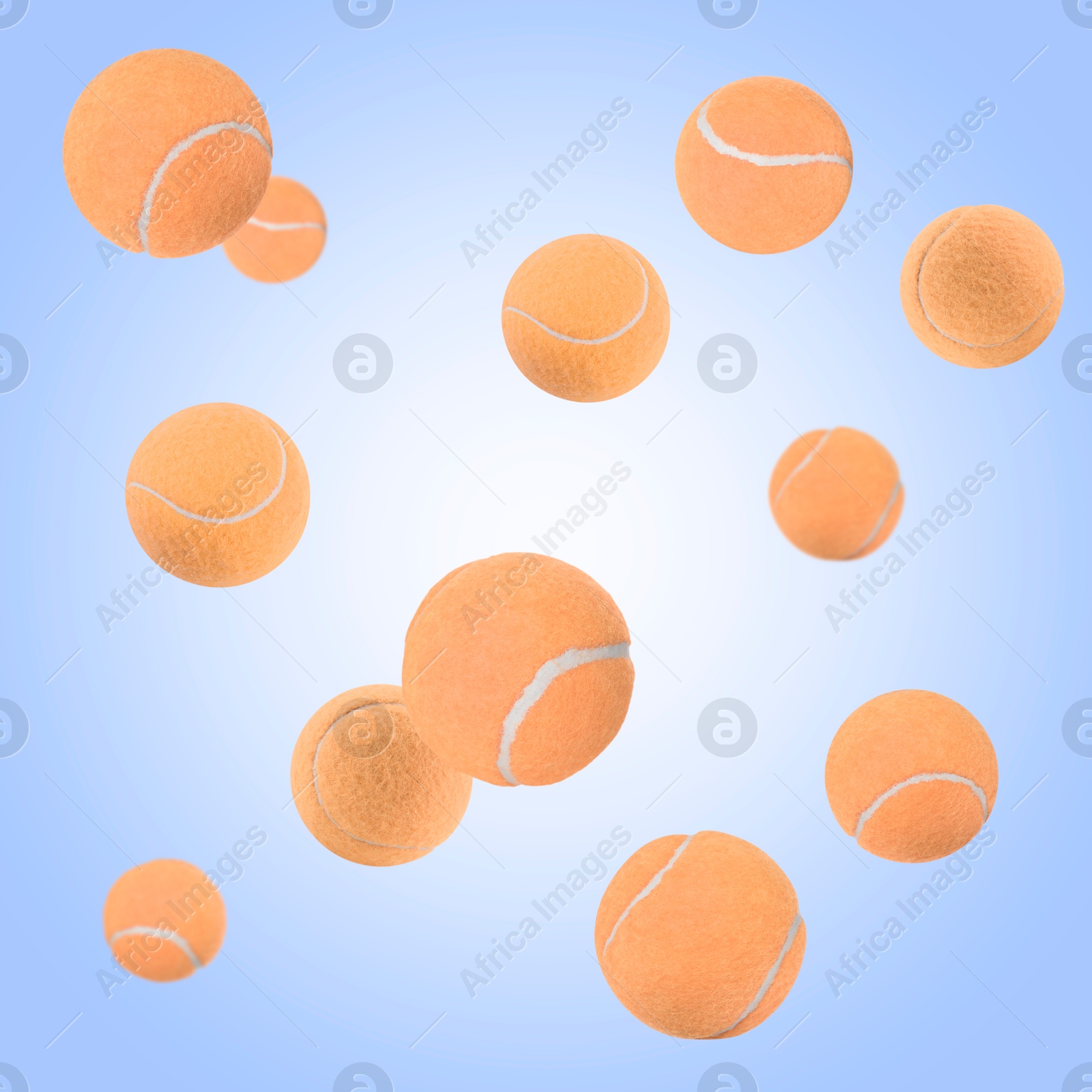 Image of Many pale orange tennis balls flying on light blue gradient background