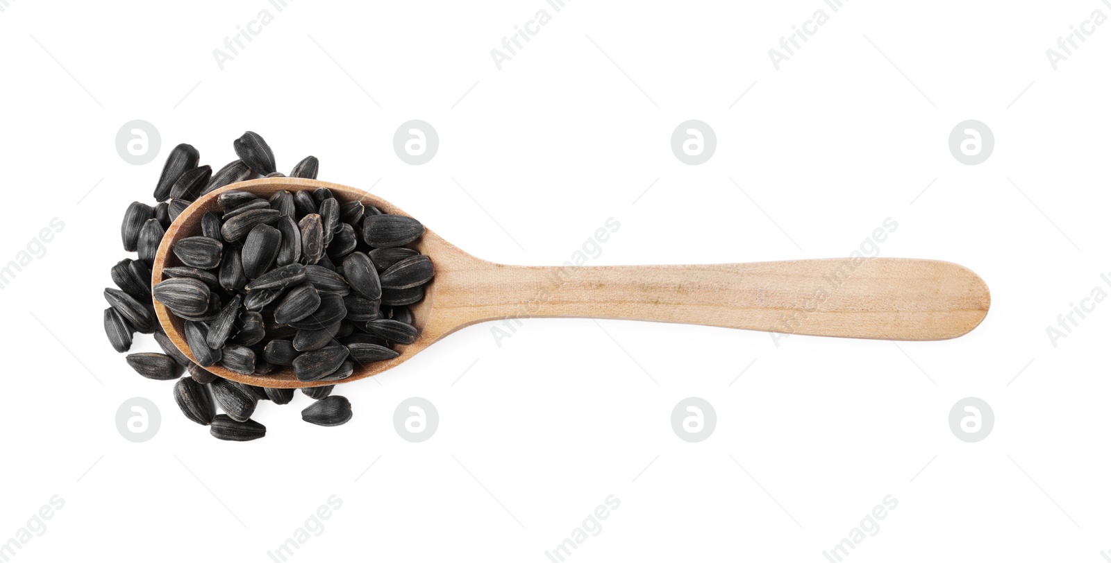 Photo of Sunflower seeds in wooden spoon isolated on white, top view