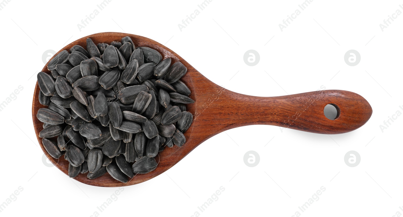 Photo of Sunflower seeds in wooden spoon isolated on white, top view