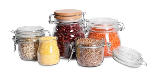 Different cereals and legumes in glass jars isolated on white