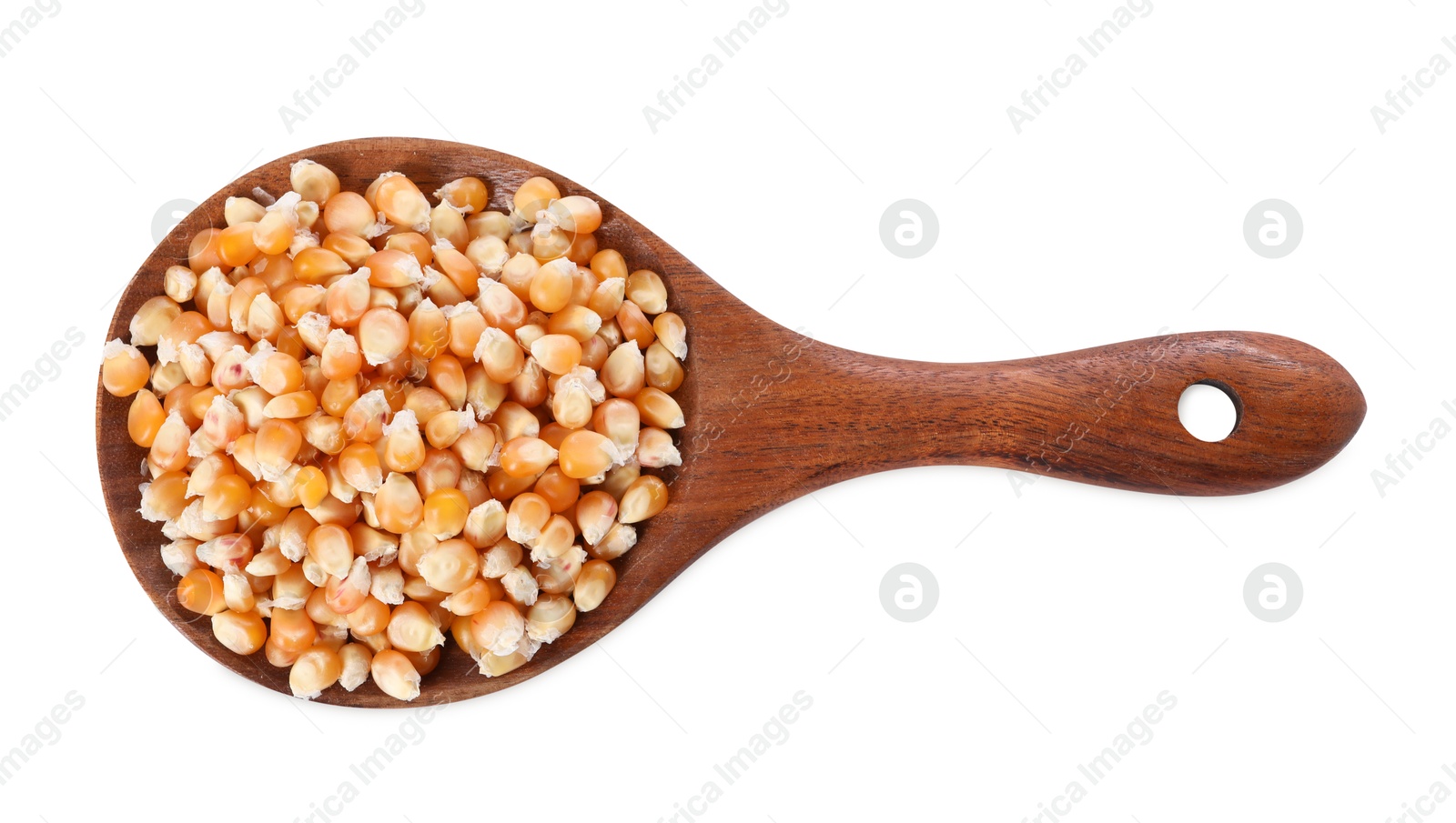 Photo of Fresh corn kernels in wooden spoon isolated on white, top view