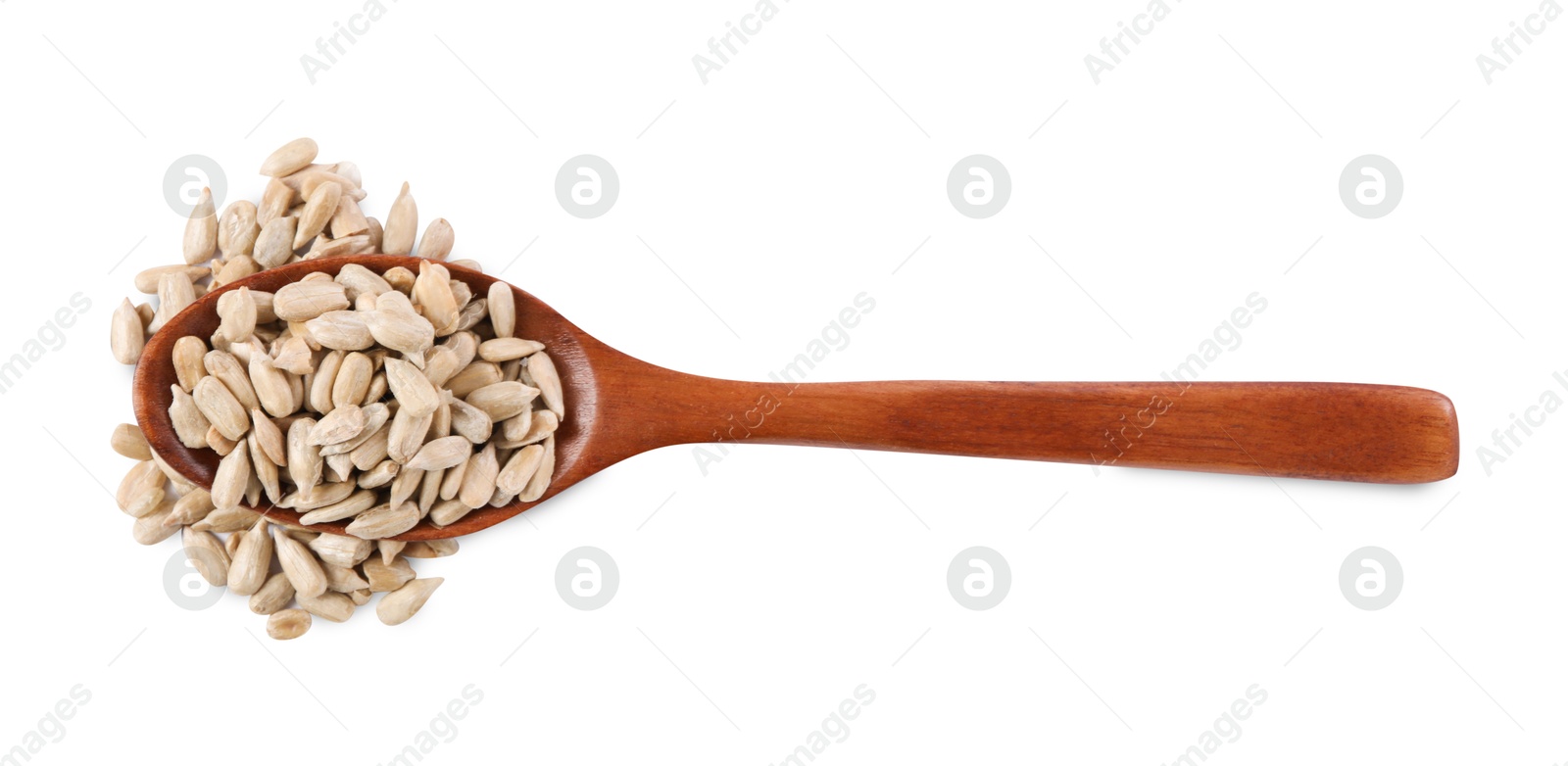 Photo of Peeled sunflower seeds in wooden spoon isolated on white, top view