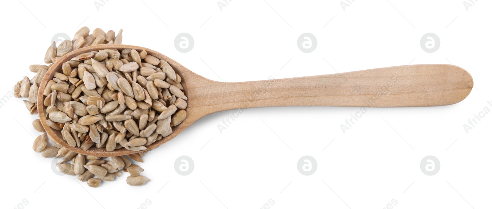 Photo of Peeled sunflower seeds in wooden spoon isolated on white, top view