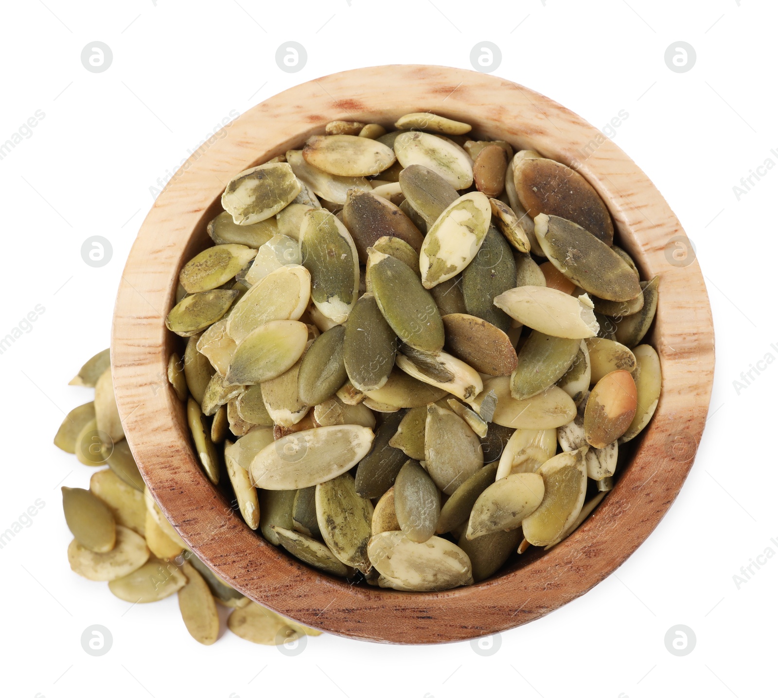 Photo of Peeled pumpkin seeds in wooden bowl isolated on white, top view