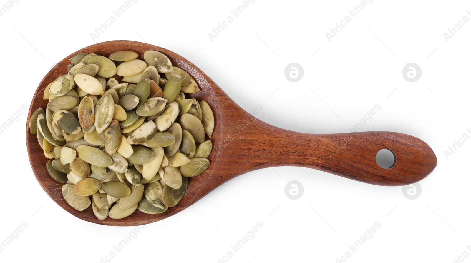 Photo of Peeled pumpkin seeds in wooden spoon isolated on white, top view