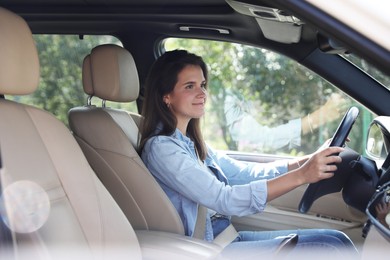 Photo of Woman holding steering wheel while driving car