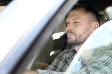 Photo of Man driving modern car, view of outside