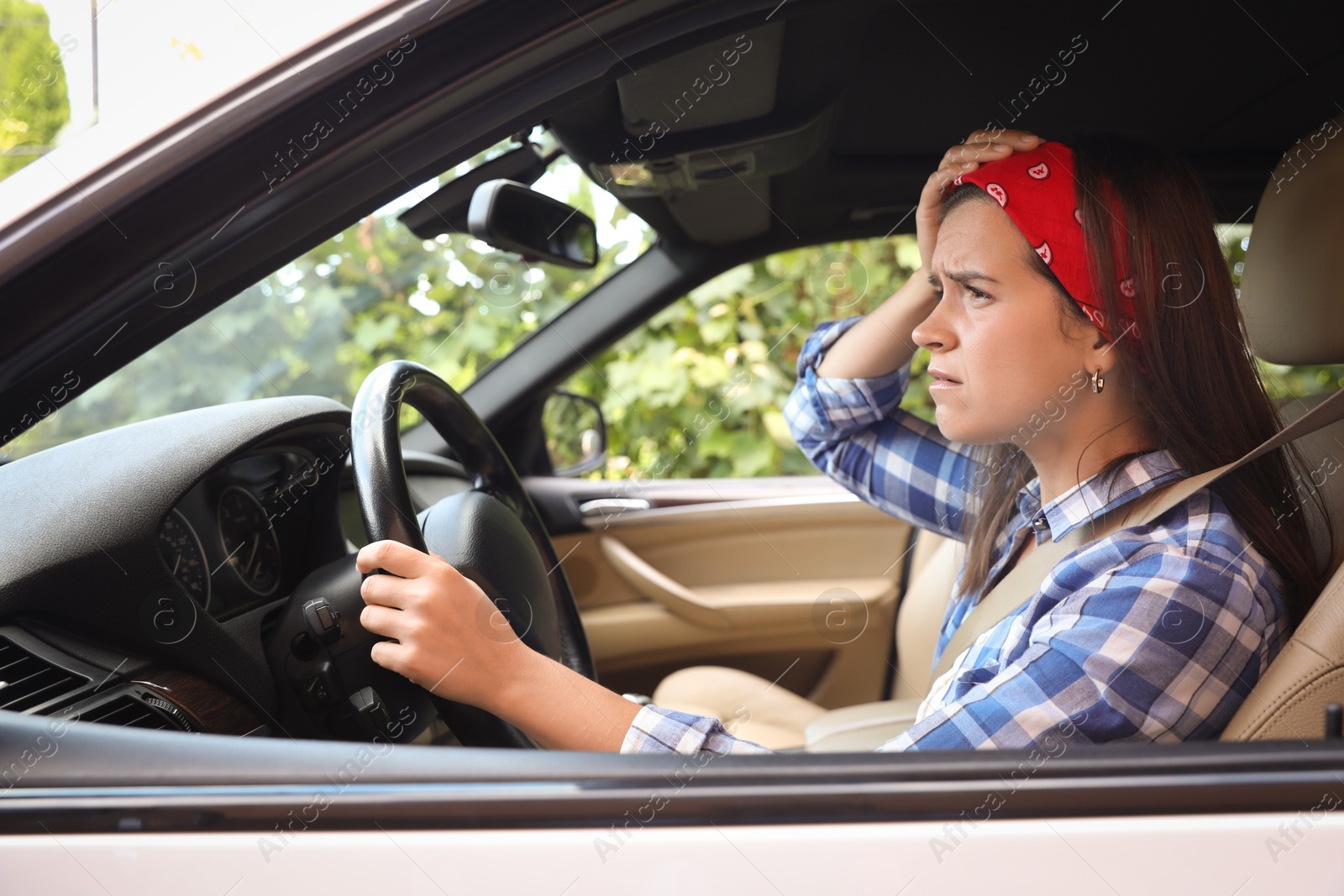 Photo of Emotional woman holding steering wheel while driving car, view from outside