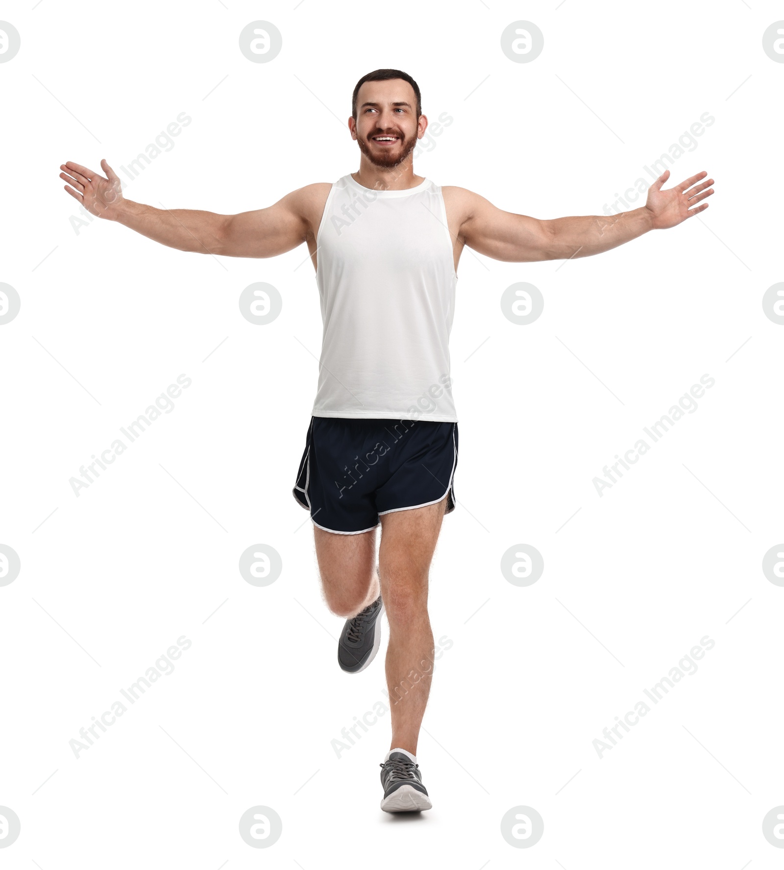 Photo of Handsome young man running on white background