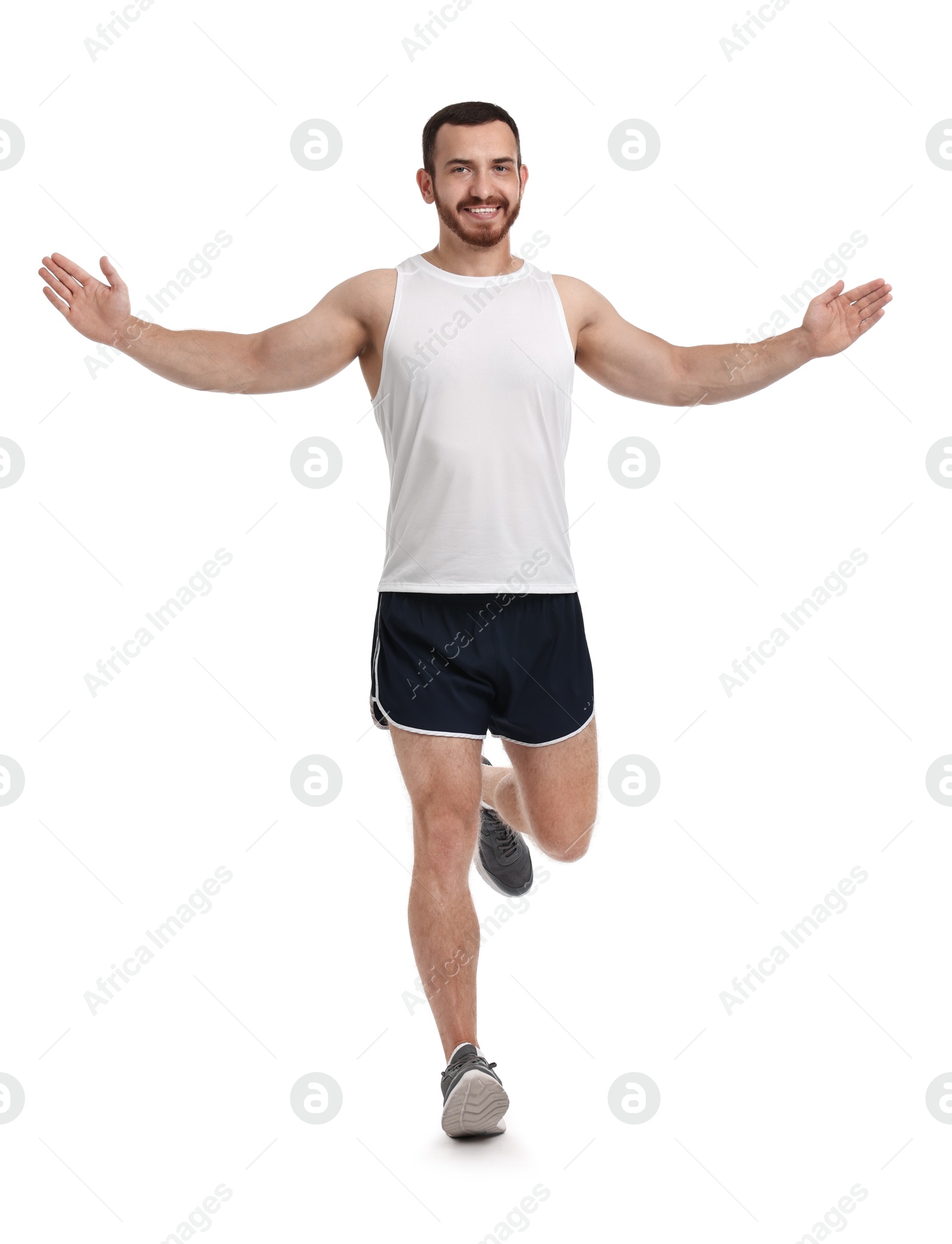 Photo of Handsome young man running on white background