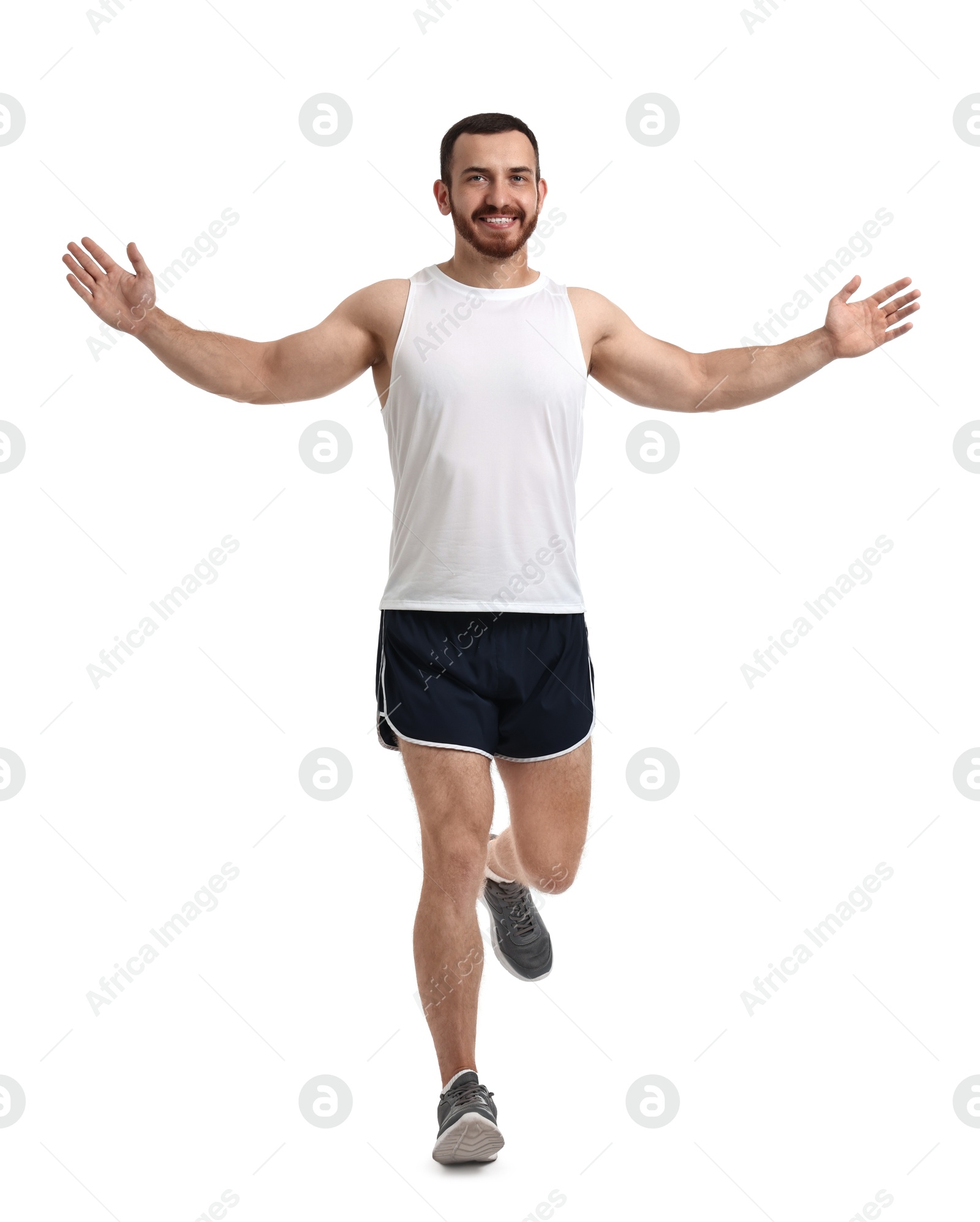 Photo of Handsome young man running on white background