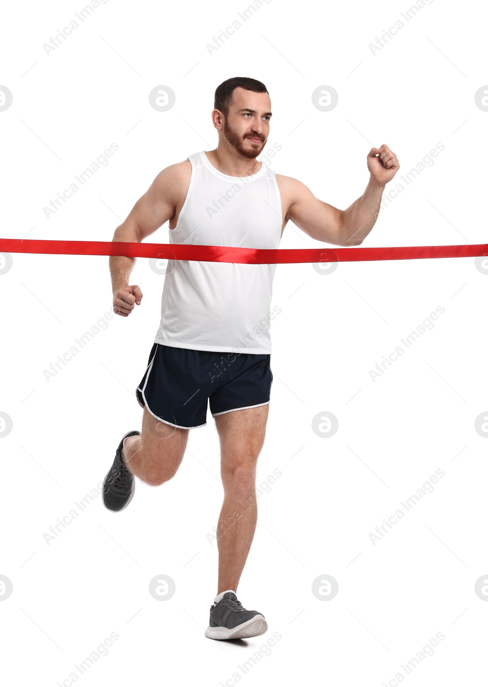 Photo of Handsome young man crossing red finish line on white background