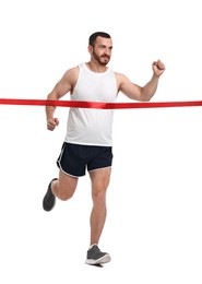 Photo of Handsome young man crossing red finish line on white background