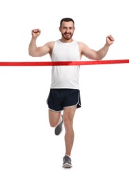 Photo of Handsome young man crossing red finish line on white background