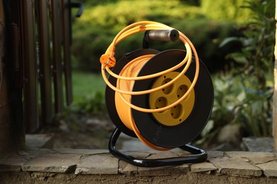 One extension cord reel outdoors. Electrician's equipment