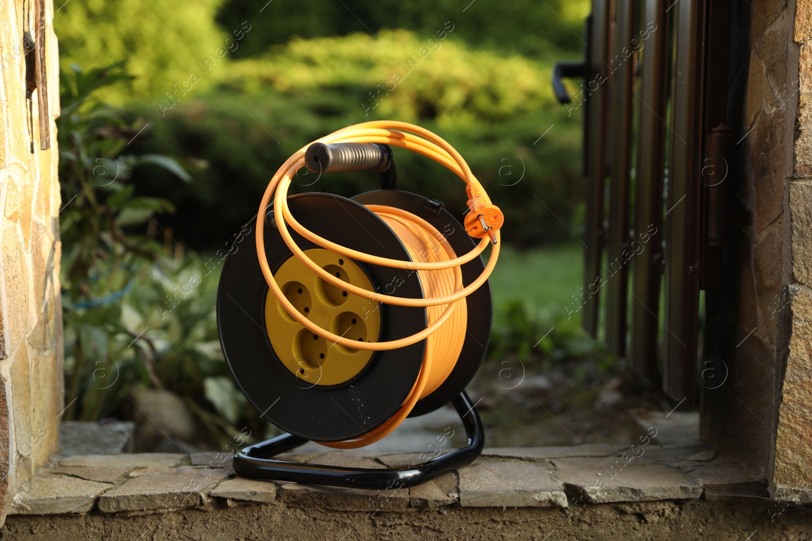 Photo of One extension cord reel outdoors. Electrician's equipment