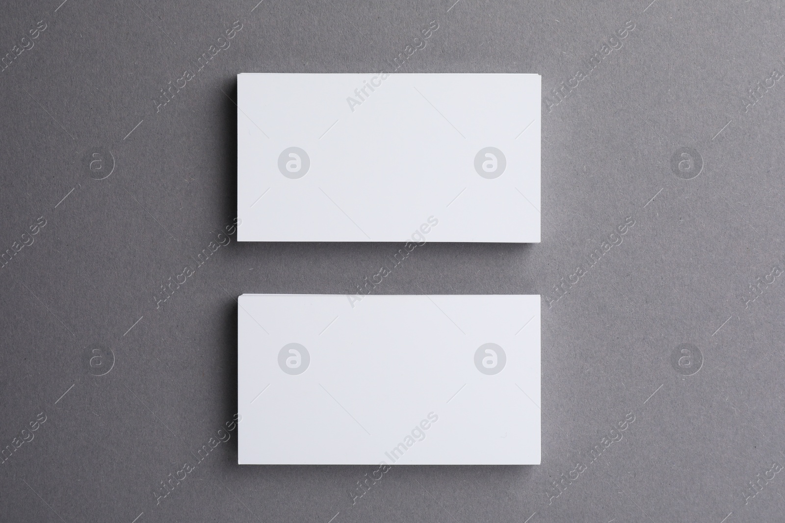 Photo of Blank business cards on grey background, top view. Mockup for design