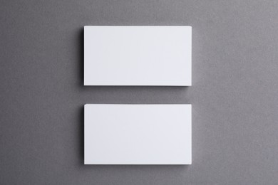 Photo of Blank business cards on grey background, top view. Mockup for design