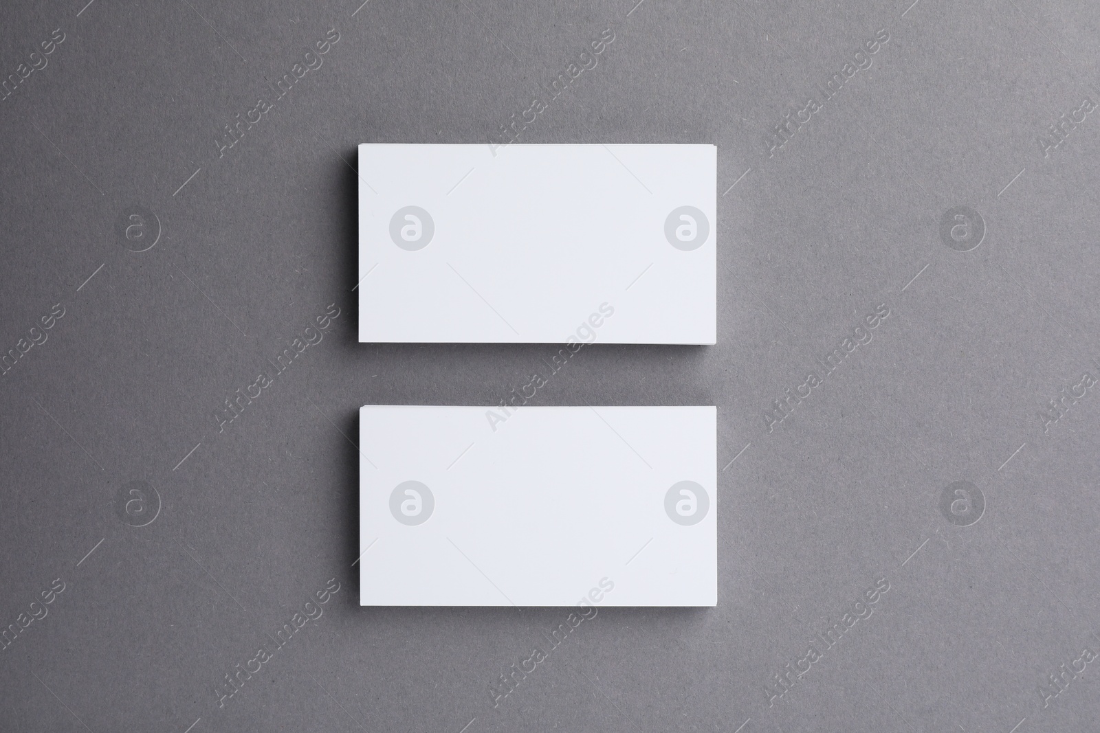 Photo of Blank business cards on grey background, top view. Mockup for design