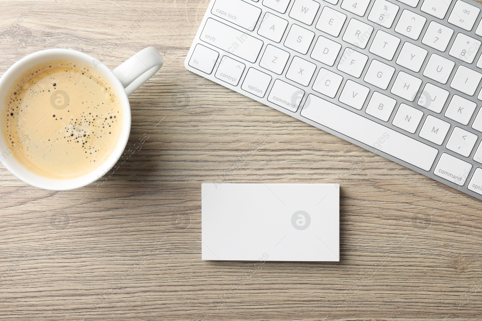 Photo of Blank business cards, coffee and keyboard on wooden table, flat lay. Mockup for design