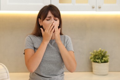 Photo of Tired woman suffering from sinusitis at home