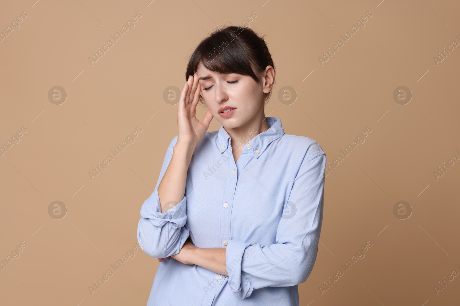 Photo of Woman suffering from sinusitis on beige background