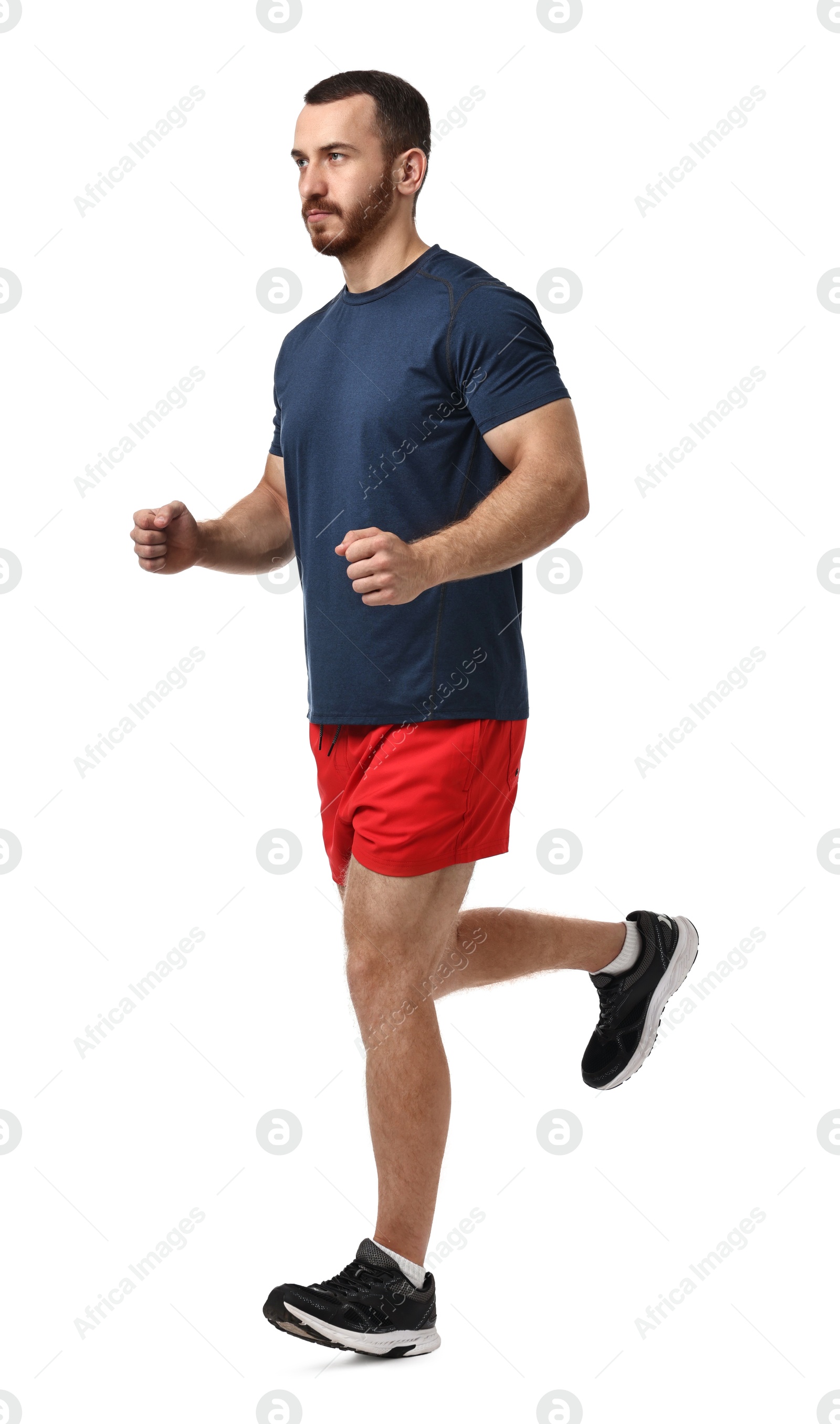 Photo of Handsome young man running on white background