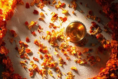 Photo of Diwali celebration. Diya lamp and beautiful flowers on light background, top view