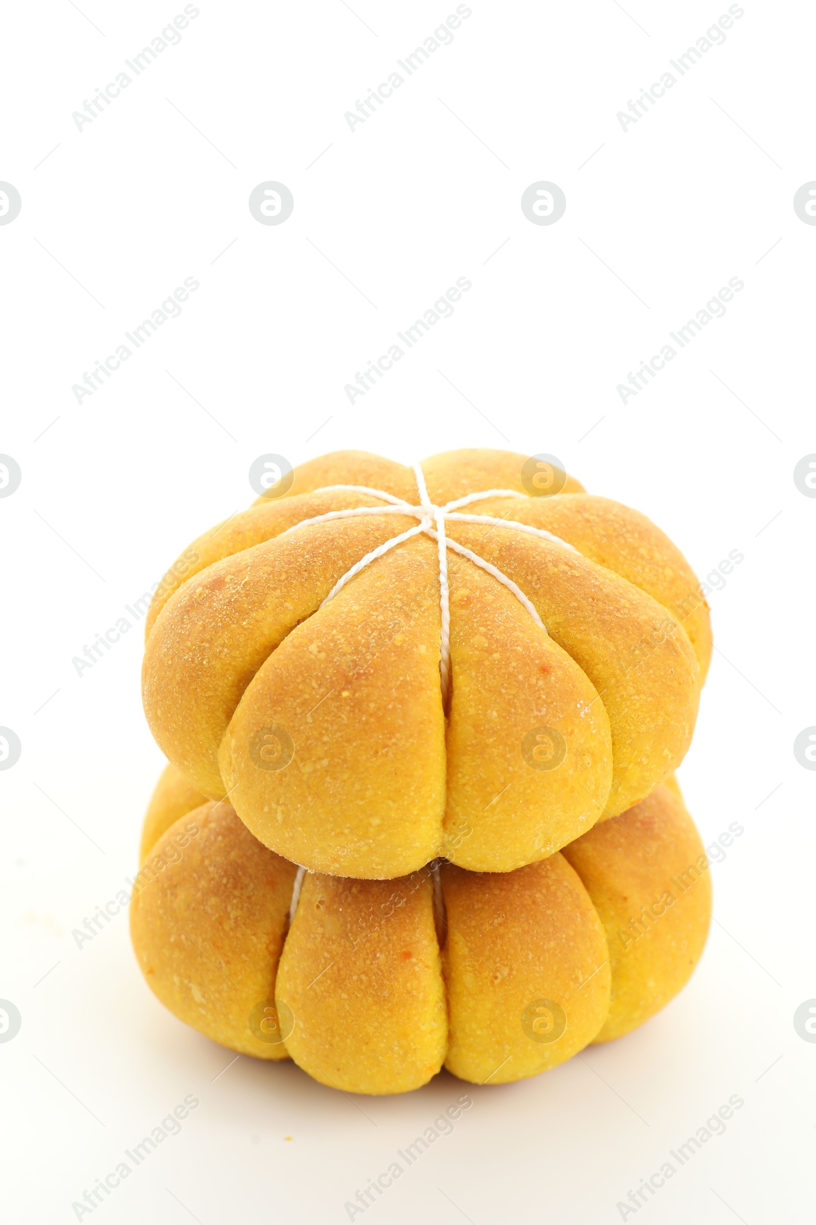 Photo of Stack of tasty pumpkin shaped buns on white background