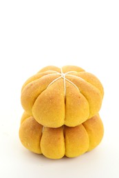 Photo of Stack of tasty pumpkin shaped buns on white background