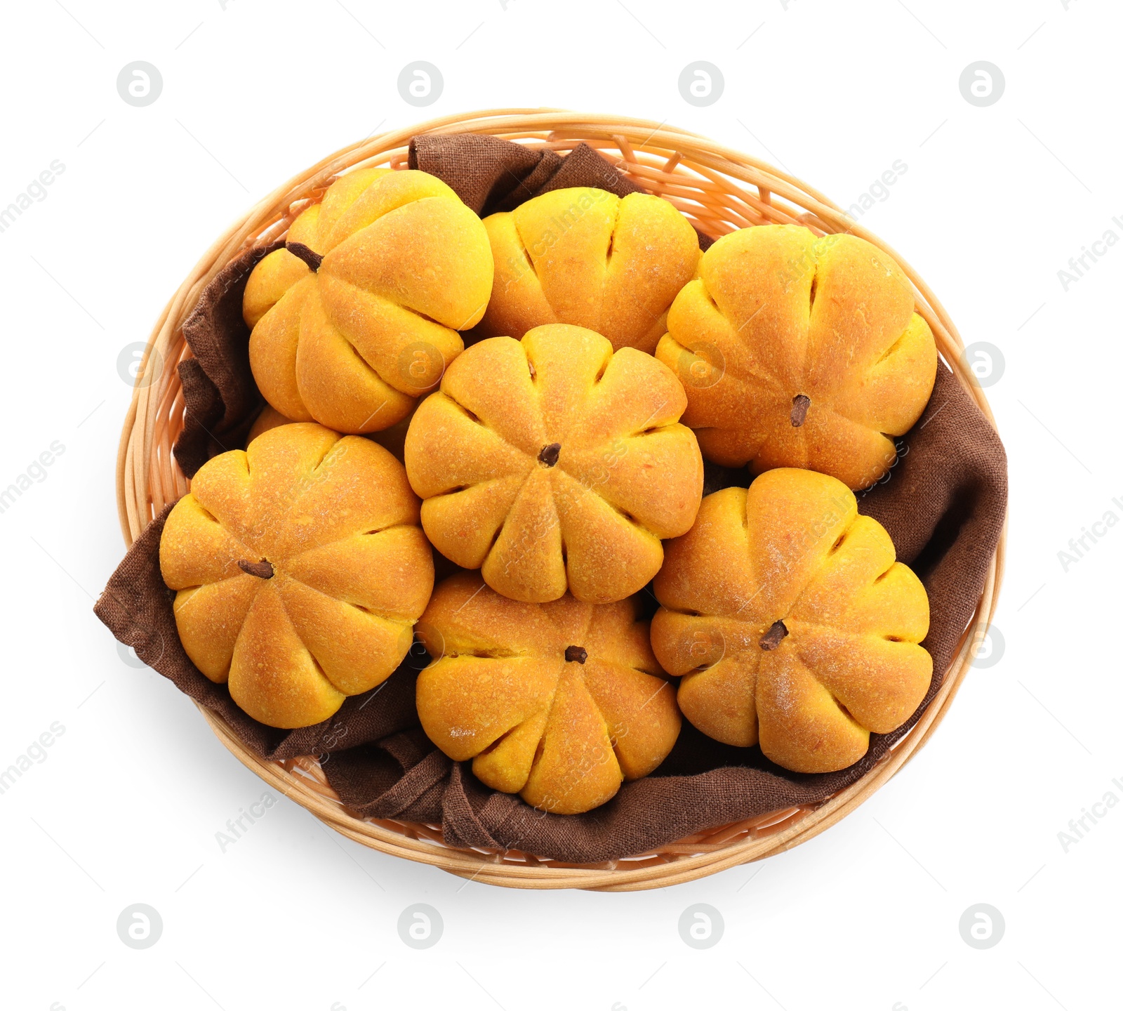 Photo of Wicker basket with tasty pumpkin shaped buns isolated on white, top view