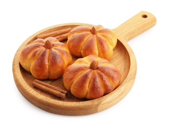 Photo of Tasty pumpkin shaped buns and cinnamon sticks isolated on white