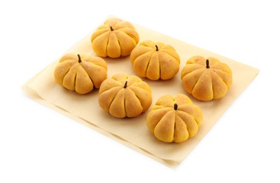 Photo of Parchment with tasty pumpkin shaped buns isolated on white