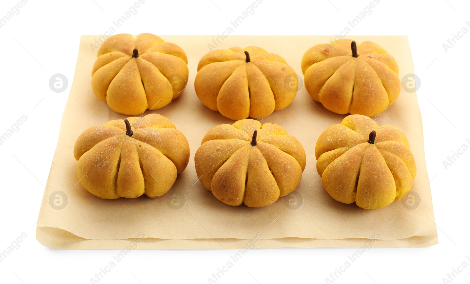 Photo of Parchment with tasty pumpkin shaped buns isolated on white