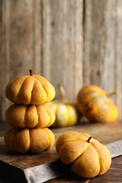 Photo of Tasty pumpkin shaped buns on wooden table