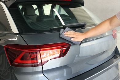 Man wiping auto with rag at car wash, closeup