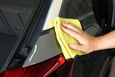 Photo of Man wiping auto with rag at car wash, closeup