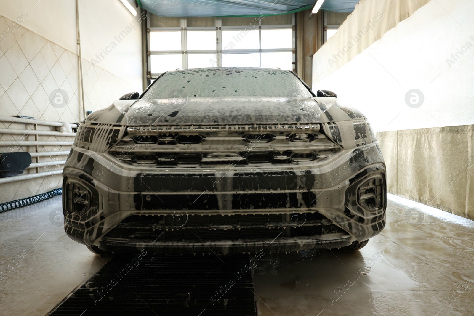 Photo of Auto covered with cleaning foam at car wash