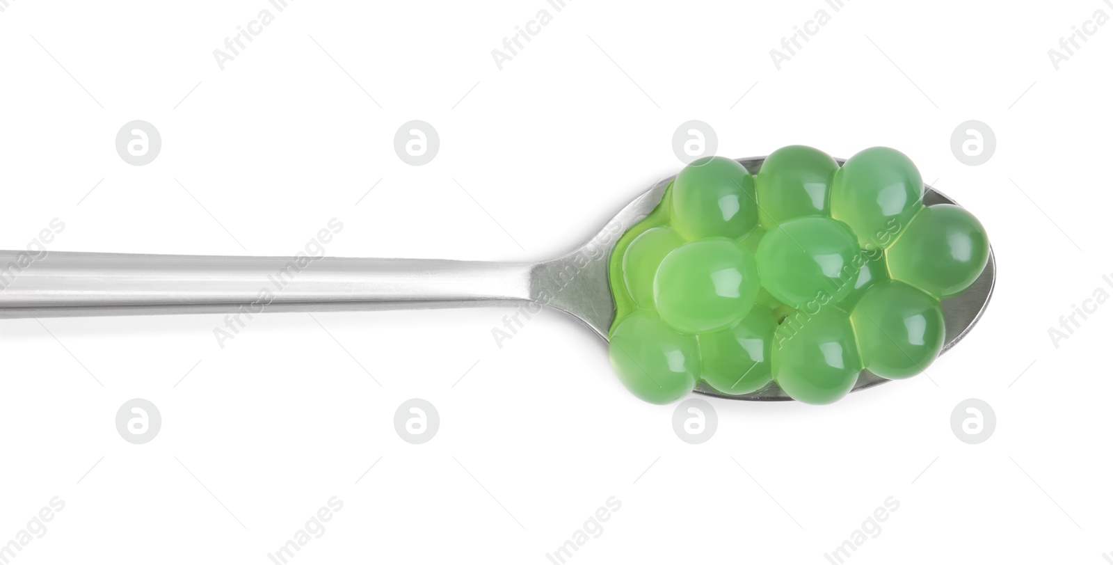 Photo of Bright tapioca pearls in spoon isolated on white, top view