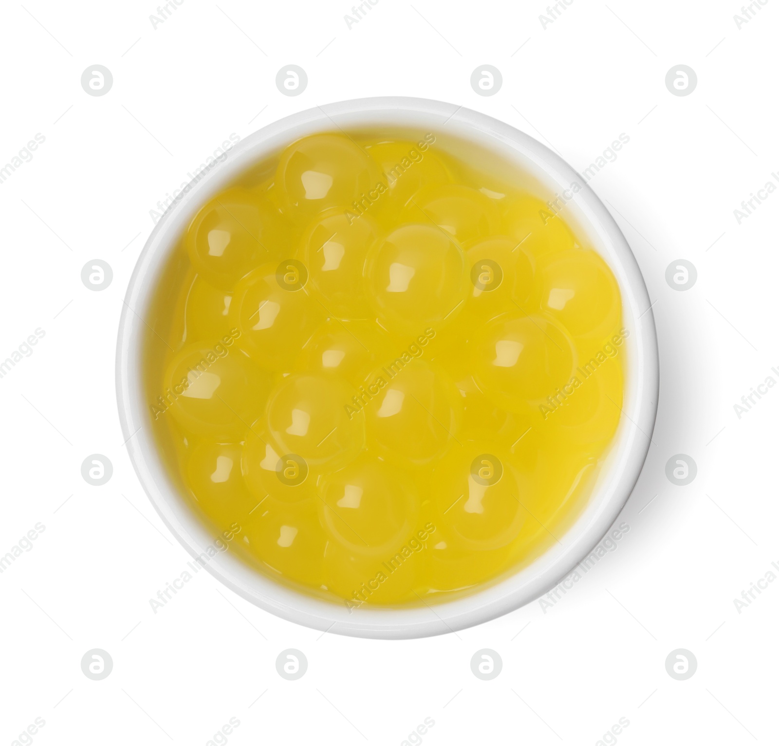 Photo of Bright tapioca pearls in bowl isolated on white, top view