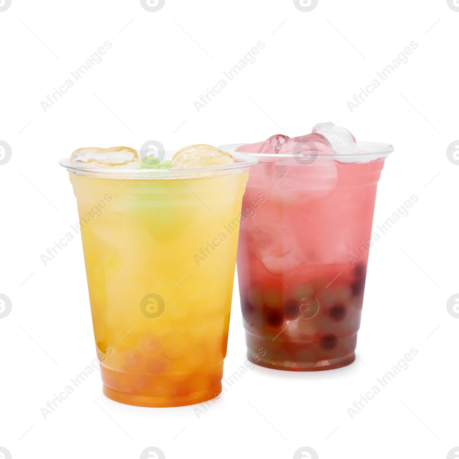 Photo of Tasty bubble tea in plastic cups isolated on white