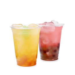 Photo of Tasty bubble tea in plastic cups isolated on white